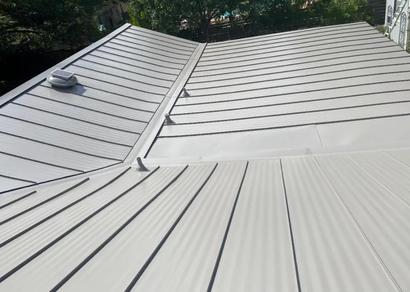 Solar attic fan installed on a metal roof for Roof Ventilation in Normal